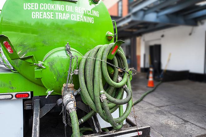 grease trap pumping truck in action in Aventura, FL